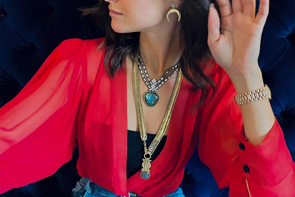 A Girl Wears Gold And Silver Necklaces